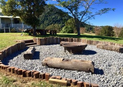 Fire pit entertaining area with bridge timber seating, gravel base