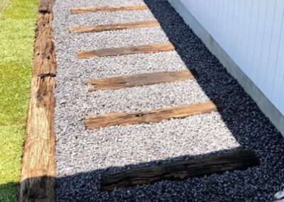 Pathway using recycled railway timbers and pebbles